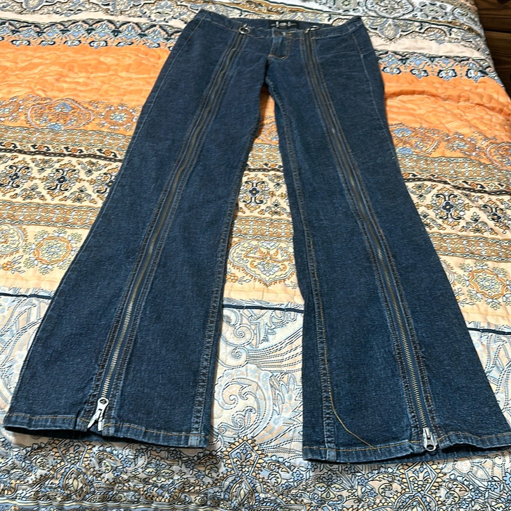 Size 9 gently used and loved wide legged jeans with multiple zippered trim.